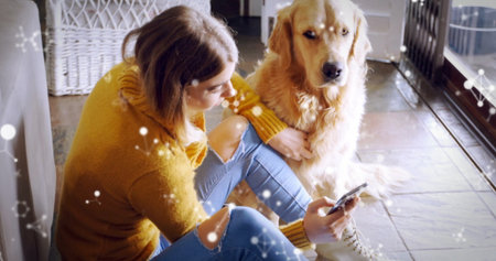 Leaning woman wearing sweater on wicker chest at home, petting golden retriever holding smartphone. Casual, cozy, lifestyle, comfort, companionship, relaxed, modernの写真素材