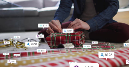 Wrapping woman placing plaid paper on gift at living room floor, with ribbon spool and overlays....