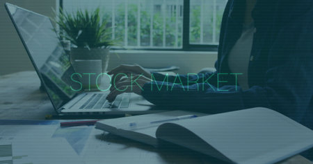 Typing woman wearing blazer at home office, with laptop charts and graphs stock market, copy space. Professional, productivity, minimalistic, digital, financial, workspace, greeneryの写真素材