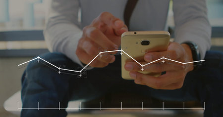 Tapping gold smartphone screen, viewing data overlay in grey shirt on office bench with wristwatch. Technology, finance, professionalism, modern, analytics, corporate, data visualizationの写真素材