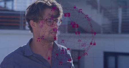 Standing male wearing eyeglasses and blue shirt on rooftop terrace with magenta network icons....