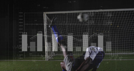 Executing bicycle kick soccer player sending ball toward goal on grass under lights, with analytics. Athletics, competition, dynamism, innovation, motion, strategy, enduranceの写真素材