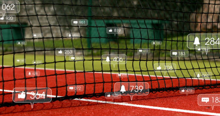 Displaying tennis net presenting floating social media icons on red court with grass background....