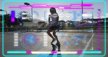 Tennis player swinging racket and hitting ball in sunset court, with fence and holographic overlay. Athletic, futuristic, sports, competition, outdoor, technology, performanceの写真素材