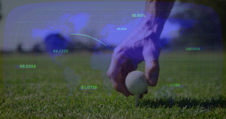 Golfer hand positioning golf ball on tee on trimmed grass, showing world map overlay, copy space. Sports, outdoor, technology, analytics, landscape, precision, recreationの写真素材
