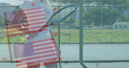 Swinging tennis player holding racket wearing white and red outfit on tennis court, with flag motif. Athleticism, sport, competition, dynamic, outdoor, vibrant, determinationの写真素材
