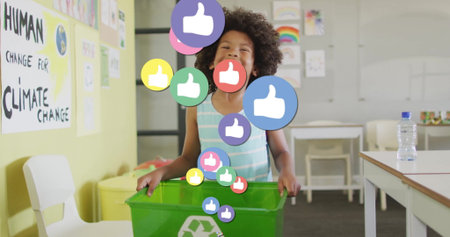 Holding rim of green recycling bin, boy standing in school classroom, with digital thumbs-up icons. Sustainability, education, environmentalism, digital, optimistic, eco-friendly, creativityの写真素材