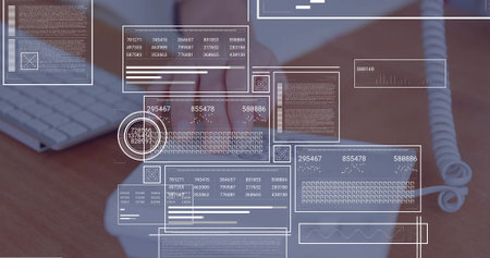 Worker wearing blazer clicking white mouse at desk, with white keyboard, phone cable, data overlays. Technology, data, analytics, productivity, professional, digital, officeの写真素材