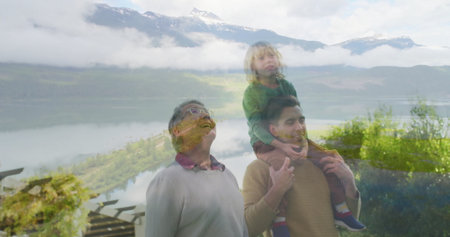 Standing family trio facing mountain vista over lake on deck, with wooden railing and pergola beams. Scenic, adventure, bonding, tranquility, exploration, nature, resilienceの写真素材