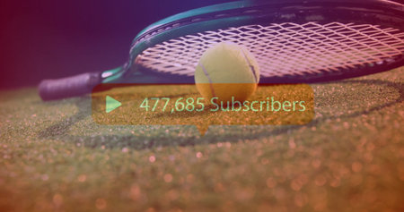Showing tennis racket head holding yellow ball on grass court, with subscriber count overlay. Sports equipment, athletic, action, outdoor, competitive, vibrant, dynamicの写真素材