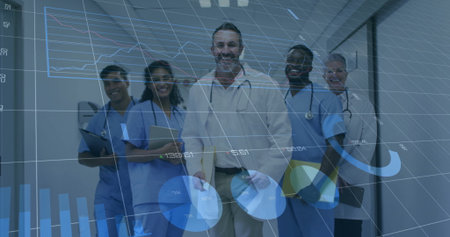 Doctors posing in hospital corridor in lab coats with stethoscopes tablet under data overlay....