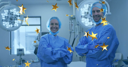 Standing surgeons wearing gowns in surgical suite, with surgical lights, monitor and gold stars....