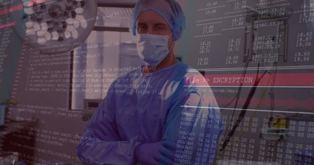 Standing cross-armed surgeon wearing gown in procedure room, with surgical light. Medical,...