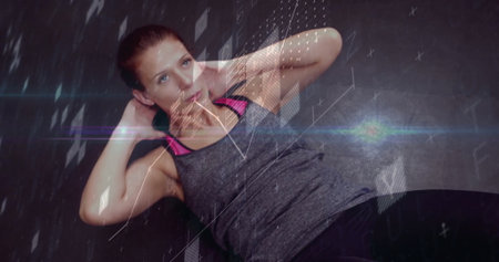 Crunching woman in tank top, leggings on dark mat performing abdominal workout in gym, graphics....