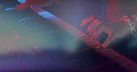 Playing musician's hands pressing keyboard with watch on stage, colored lights and haze. Piano,...