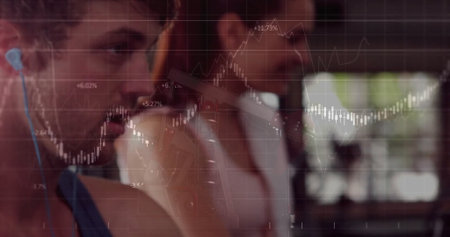 Focusing fitness partners working out at gym, with wireless earphones and financial chart overlay. Activewear, motivation, technology, fitness, health, collaboration, minimalistの写真素材