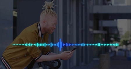 Leaning man in bomber jacket checking phone on bicycle at office, with waveform overlay, copy space....
