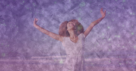 Standing Black woman stretching arms outward and smiling joyfully at shoreline, with purple overlay....