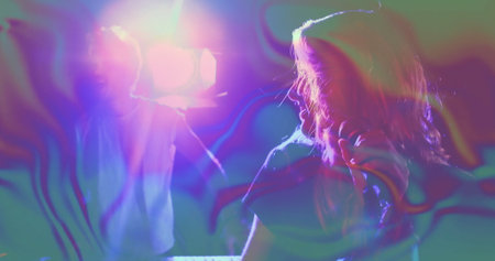 Performing female singer holding microphone near keyboard on stage, with swirling haze, copy space....