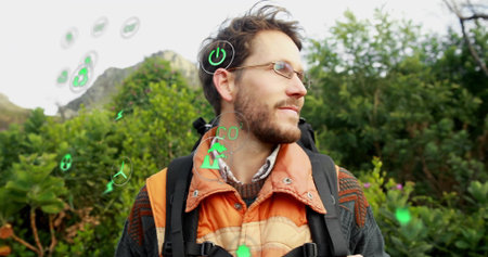Standing man wearing vest and backpack at forest edge, with floating green digital icons. Outdoor, sustainability, ecofriendly, renewable, conservation, wilderness, environmentalismの写真素材