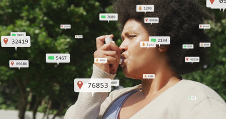 Holding asthma inhaler middle aged woman breathing outdoors in park with floating digital icons....