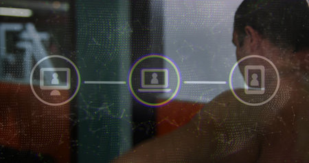 Leaning male wearing sleeveless top viewing desk screen at office, with network icons, copy space....