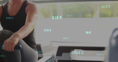 Woman in black sportswear using rowing machine at gym, with windows, currency overlays, copy space....
