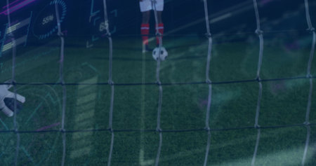 Balancing soccer player placing foot on ball on stadium turf by goal net, with training overlays....