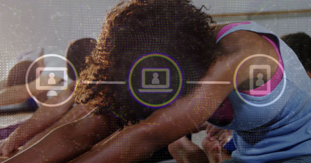 Bending woman in blue top performing forward-bend stretch at yoga studio, with mats and UI icons....