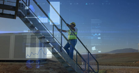 Climbing engineer wearing hard hat and vest ascending staircase at wind farm, with data overlays....