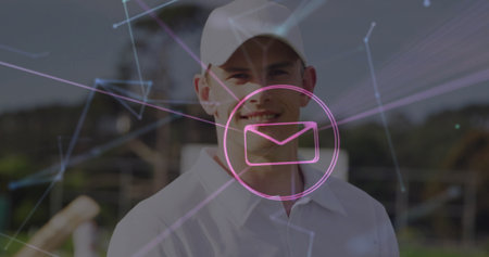 Standing man in baseball cap, shirt showing magenta envelope icon and network lines in rural field. Technology, communication, connectivity, outdoor, casual, rural, digitalの写真素材