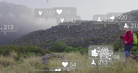 Traversing solo hiker in red jacket navigating misty hillside with copy space. Adventure,...
