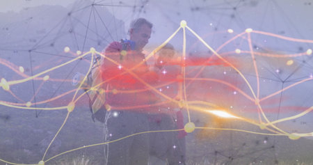 Hiking couple studying network overlay on misty mountain slope, with backpacks and curve plots. Adventure, exploration, technology, outdoor, rugged, connectivity, teamworkの写真素材