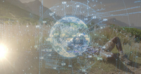 Lying hiker in boots viewing holographic globe data among tall meadow grasses at sunset, copy space....