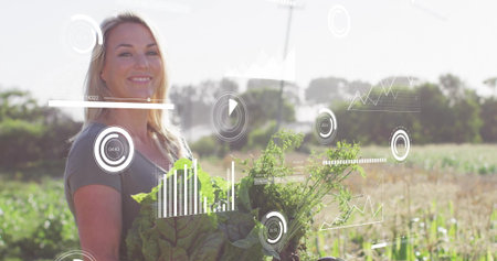 Holding leafy greens, female farmer viewing farming data overlays in vegetable field, copy space....