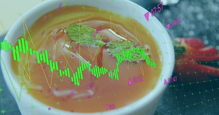 Displaying bowl of tomato soup on kitchen countertop, with mint and spoon. Gourmet, culinary,...