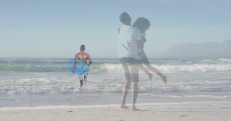 Lifting couple above sand on beach, overlaying surfer in turquoise trunks carrying blue bodyboard....