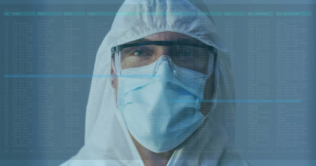 Laboratory technician analyzing log overlay in cleanroom, wearing hood coverall mask and goggles....