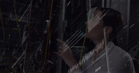 IT technician inspecting server rack in server room, with patch cables, digital graphs, copy space....