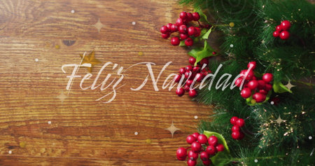 Feliz Navidad text image over Christmas decorations with holly and pine branches. holiday, festive, seasonal, greeting, celebration, winterの写真素材