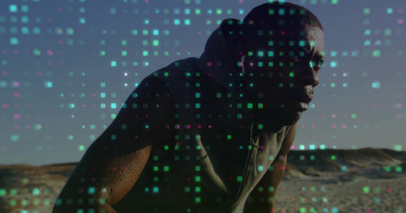 Sweating man wearing sleeveless hoodie leaning forward on sand dunes, with digital pixel overlay. Athlete, fitness, digital, data visualization, outdoor, beach, energeticの写真素材