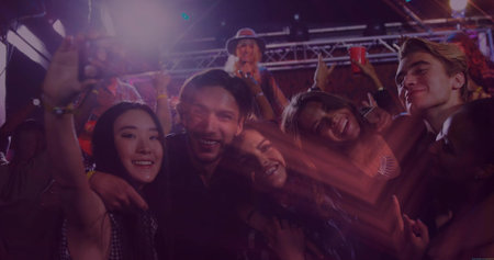 Six friends taking selfie in bar, with phone, red cups, singer in hat holding microphone. Celebration, nightlife, camaraderie, vibrant, entertainment, social, energeticの写真素材