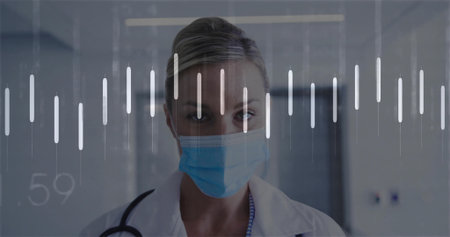 Dr standing in hospital corridor, wearing surgical mask, white coat, stethoscope, waveform overlay. Medical, healthcare, professional, clinical, diagnostic, technology, patientの写真素材