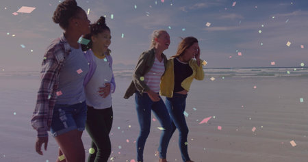 Strolling four friends laughing together along sandy beach at ocean edge, with floating fragments. Coastline, friendship, leisure, vibrant, outdoor, serenity, harmonyの写真素材