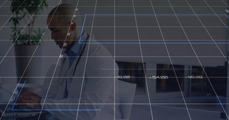 Typing male doctor wearing lab coat, stethoscope at clinic desk with laptop grid overlay copy space. Medical, healthcare, technology, telemedicine, innovation, digital, professionalの写真素材