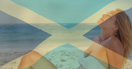 Reclining woman wearing white bikini on sandy shore by ocean, overlay diagonal cross, copy space. Beach, relaxation, summer, tranquil, outdoor, scenic, minimalistの写真素材