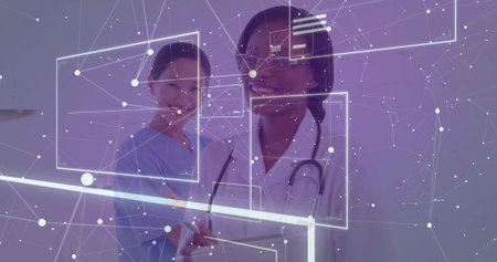 Examining interface, two medics wearing scrubs and coat using tablet and stethoscope in exam room....
