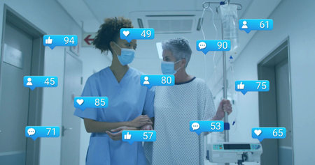 Walking masked nurse in scrubs aiding gowned patient with IV pole in corridor, reaction icons. Healthcare, compassion, support, professionalism, clinical, communication, wellnessの写真素材