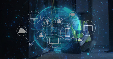 Kneeling technician in vest connecting cables in data center, with digital globe icons, copy space....
