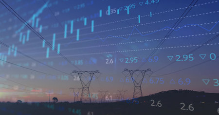 High-voltage towers and power lines stretching across rural fields at dusk with market data overlay....